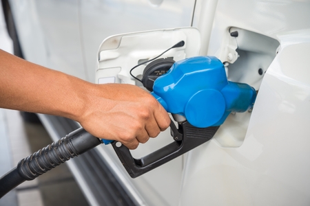 Closeup fueling blue fuel nozzle Car into Gas Tankの写真素材