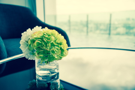 Fabric flower in clear glass jar at hotel lobby - Selective focus & Vintage filter effectの写真素材
