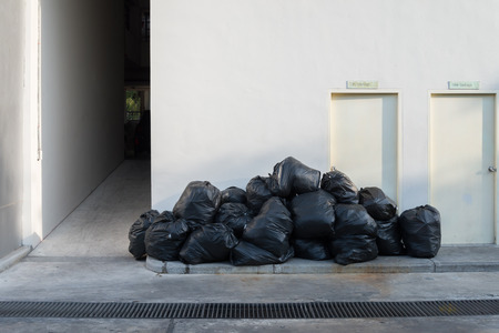 Plastic trash bags on outside street apartmentの写真素材