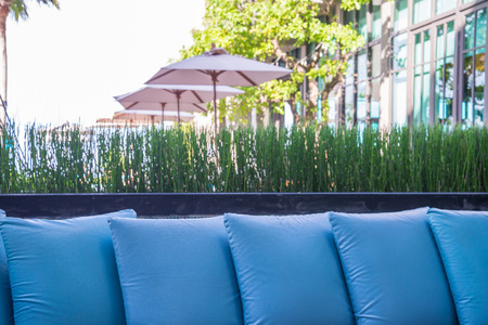 Blue pillows beside swimming pool in luxury resort travel holiday conceptの写真素材