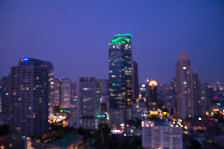 Defocused modern cityscape at night light background, blur urban skyscraper landscape twilightの写真素材