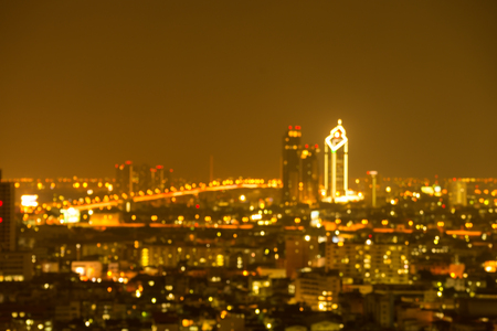 Defocused modern cityscape at night light background, blur urban skyscraper landscape twilight - Golden styleの写真素材