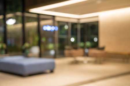 Abstract blurred background sofa chairs in hotel luxury lobby at nightの写真素材