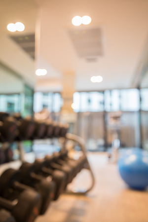 Dumbbells in modern luxury fitness center abstract blur backgroundの写真素材