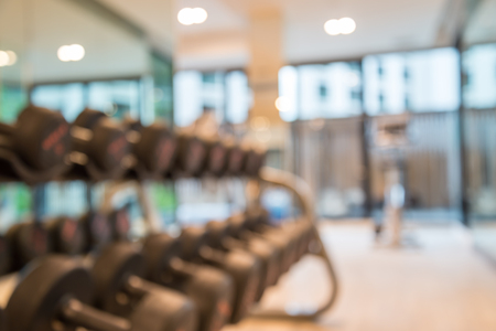 Dumbbells in modern luxury fitness training center abstract blur backgroundの写真素材