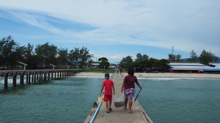 Children help their parent by carry jellyfish in plastic bag to make dry foodのeditorial素材