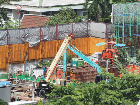 workers in construction area with crane truck and holding machine