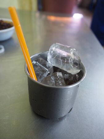 free ice in stainless cup in street food shop for customerの写真素材