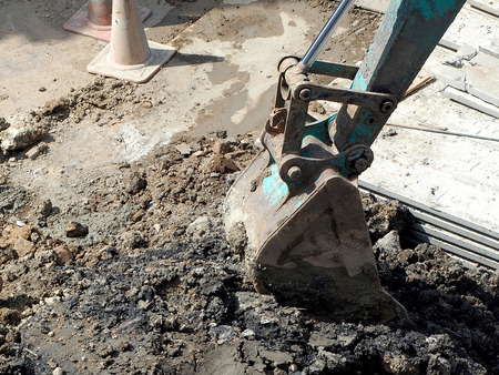 bucket of excavator is digging soil in construction siteの写真素材
