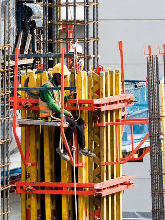 woker are woking on top of concrete structure pole with seafty setの写真素材