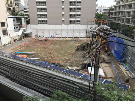 workers in construction area with crane truck and holding machineの写真素材