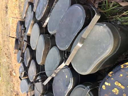 many camp pots lay on dry lawn