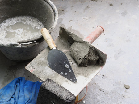 A cement and tool on floor seems worn but gray color palette creates sense of grit and determination in craftsmanshipの写真素材