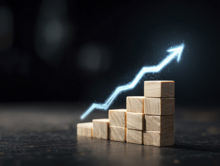 Image shows series of wooden blocks arranged in ascending order with glowing upward arrow line graph overlay, symbolizing growth and progressの素材