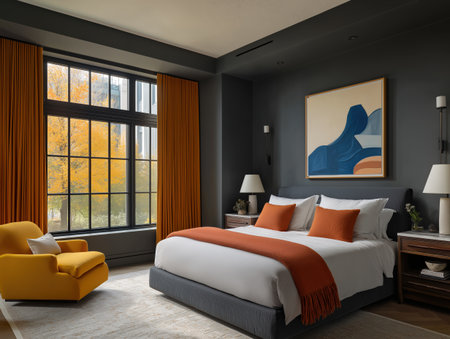 Modern bedroom with dark gray wall orange curtains orange throw and pillows beside large window overlooking autumn treeの素材