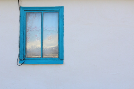 blue window on white wall autumnの写真素材