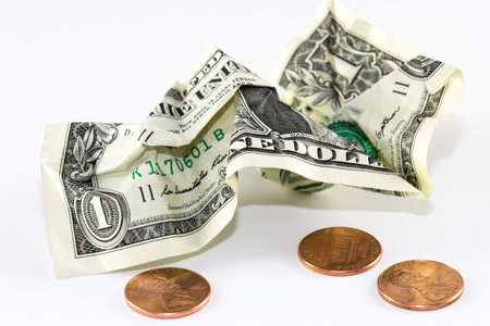 Crumpled US dollar and coins  bankruptcy or poverty concept 