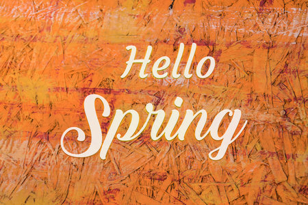 Hello Spring lettering over osb material background. Calligraphy text on wooden texture.