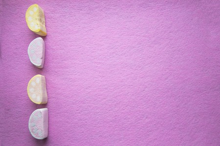 Colorful homemade marshmallow border beautiful purple textured background.の写真素材