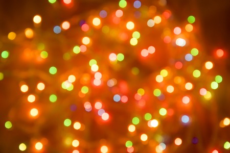 Christmas garland blurred. Abstract colorful bokeh background. Glittering holiday decoration.の写真素材