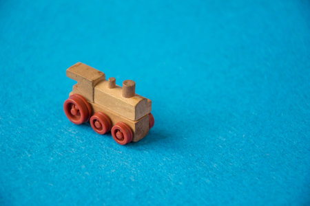 Wooden toy train on a blue background