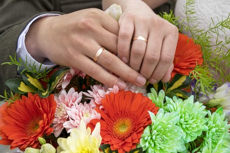 Man and woman hands in wedding ringsの写真素材