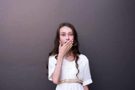 Waist-up portrait of pretty young woman in trendy outfit