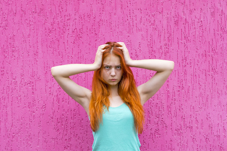 Frustrated red hair girlの写真素材