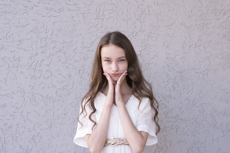 Brunette with hands near faceの写真素材