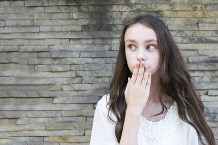 Brunette covers her mouthの写真素材