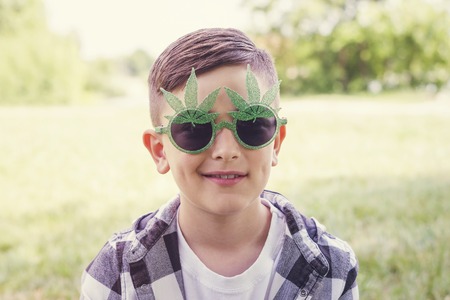 Smiling boy relaxing in parkの写真素材