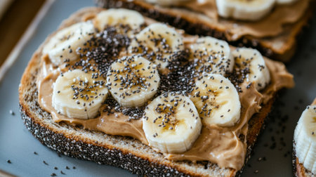 Toast topped with creamy peanut butter and banana slices, sprinkled with chia seeds, creating a nutritious and delicious breakfast optionの素材