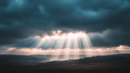A dramatic scene of a tornado against a stormy sky, with a contrast of dark clouds and rays of sunlight breaking through, illuminating the landscape belowの素材