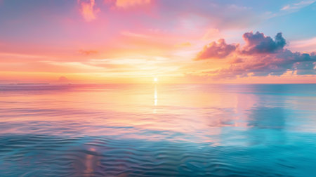 A tranquil coastal scene as the sun rises over the horizon, casting a golden reflection on the calm waters and painting the sky in hues of pink and orange.の素材