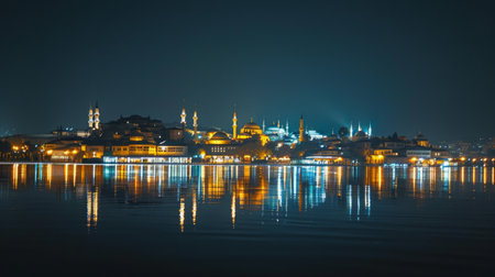 The illuminated skyline of the ancient city at night, with twinkling lights reflecting in calm waters, a mesmerizing sight.の素材