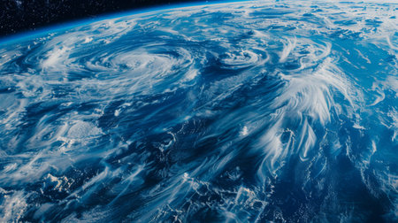 A stunning view of Earth from space, with swirling clouds and blue oceans contrasting against the dark void of spaceの素材