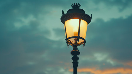 Close-up of a vintage streetlight against a dusky sky, evoking a sense of nostalgia and urban charmの素材