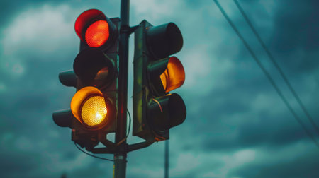 A close-up of a traffic light with an overcast sky in the background, symbolizing the predictability of traffic patternsの素材