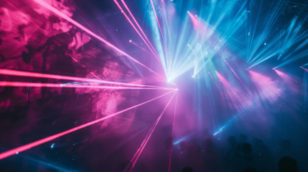Beams of light from a laser show at a music festival, creating a dynamic visual spectacleの素材