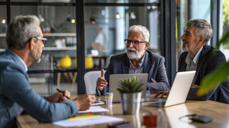 A businessman discussing financial planning and retirement savings with a senior coupleの素材