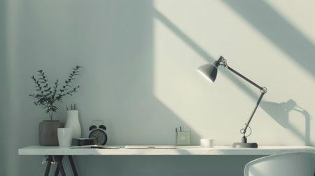 A minimalist workspace with a stylish lamp and modern accessories.の素材