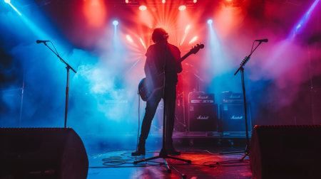 A musician performing live on stage with powerful stage monitors and amplifiersの素材