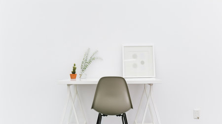 A minimalist workspace with a white desk, a black chair, and no clutter.の素材