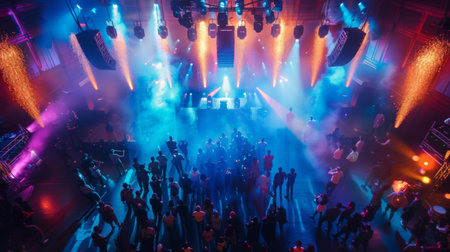 Top view of a hip-hop concert with vibrant stage effects and a lively audience.の素材