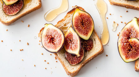 Top view of honey toast with fresh figs and a drizzle of honey, set against a white background.の素材