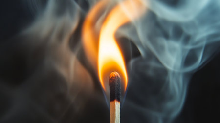 Close-up of smoke enveloping a single lit match, highlighting the fine details and movement of the smoke as it dispersesの素材