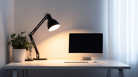 A minimalist workspace with a black LED desk lamp lighting up a white desk, featuring a clean, clutter-free setup.の素材