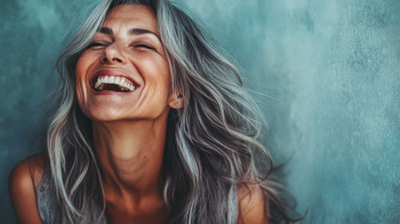 A high-quality image of a 50-year-old woman in a candid moment of laughter, capturing her joyful spirit and expressive features with a focus on her authentic smile.の素材