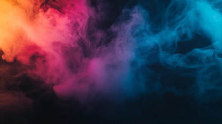 A dramatic burst of colorful smoke in shades of pink, blue, and yellow, swirling and blending together against a dark background.の素材