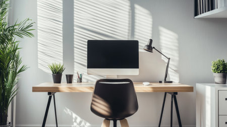 A stylish desk with a designer chair, a sleek computer setup, and decorative elements like a desk lamp and plant, set in a bright and airy office spaceの素材